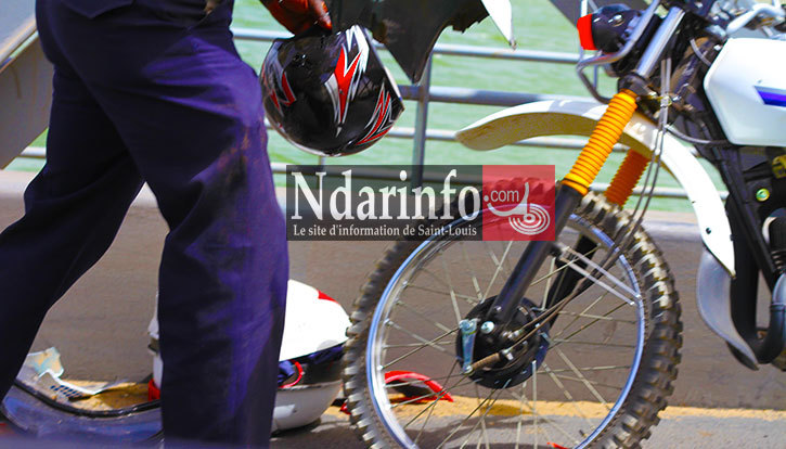 Un policier récupère le casque et les restes de la moto. Crédit Photo: NdarInfo