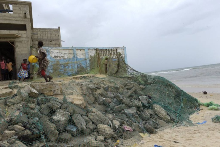 Wave breakers are used to protect houses in the Gokhou Mbathe district against the approaching sea. AFP PHOTO / SEYLLOU
