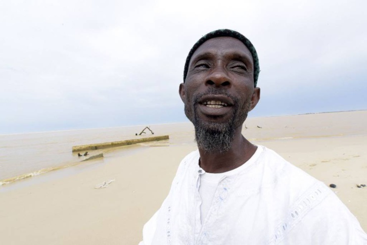 52-year-old Ameth Sene Diagne, chief of the Doune Baba Dieye village, describes how his village looked like before it was swallowed by the sea, on October 26, 2015, in Saint-Louis du Sénégal. AFP PHOTO / SEYLLOU